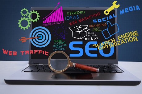 An illustration featuring a laptop computer with SEO concept and a magnifying glass in front of the laptop